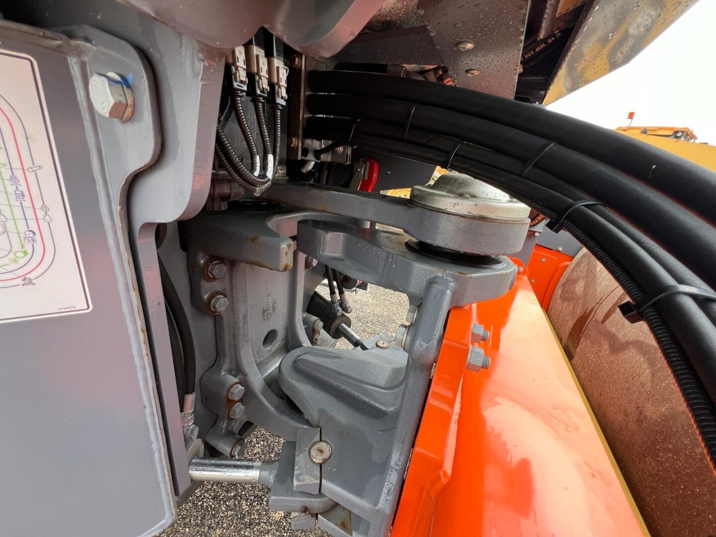 Close-up of hydraulic hoses and metal bracket