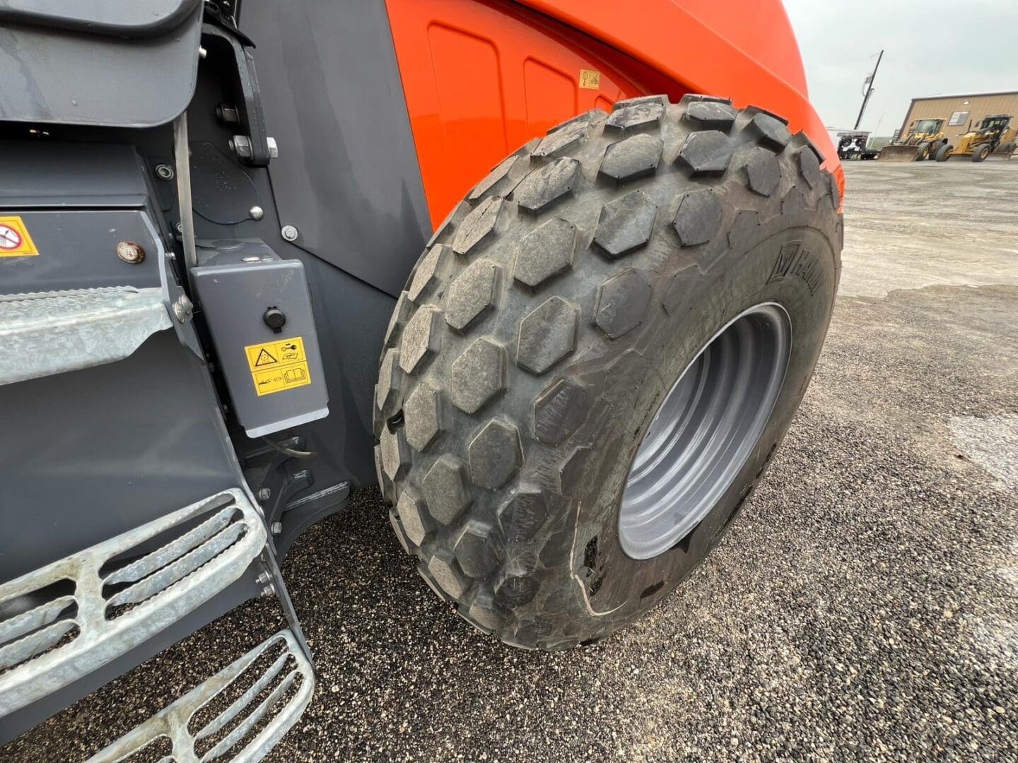 Large off-road tire on orange construction vehicle