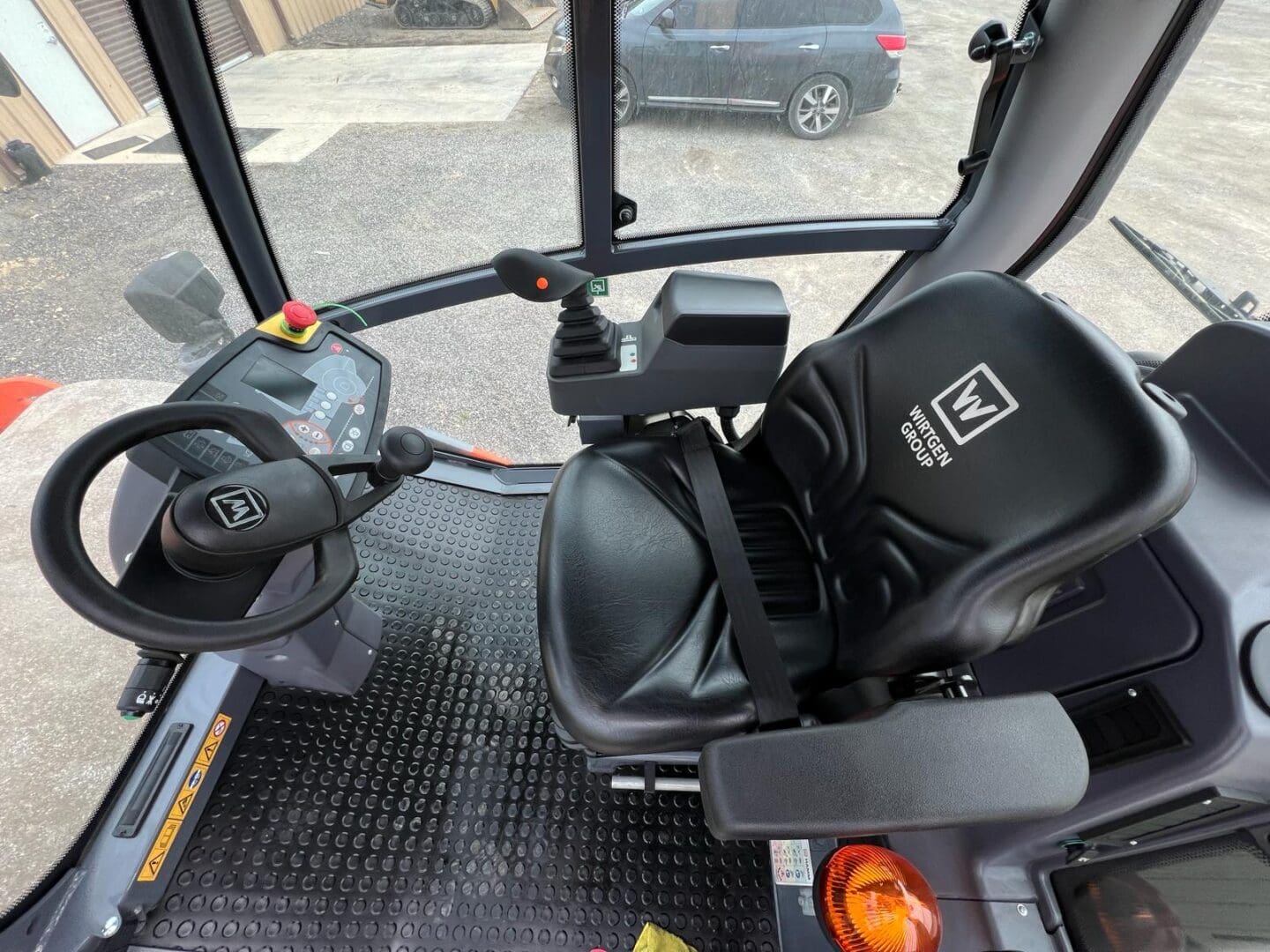 Tractor cab interior with steering and controls