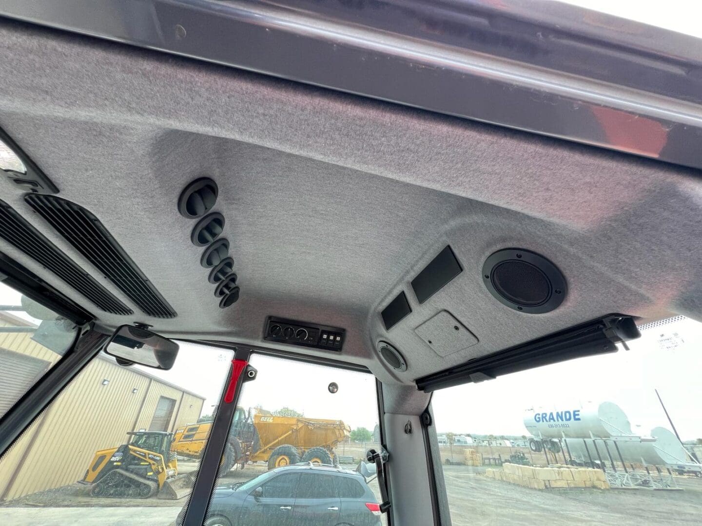 Construction equipment cabin interior with roof controls