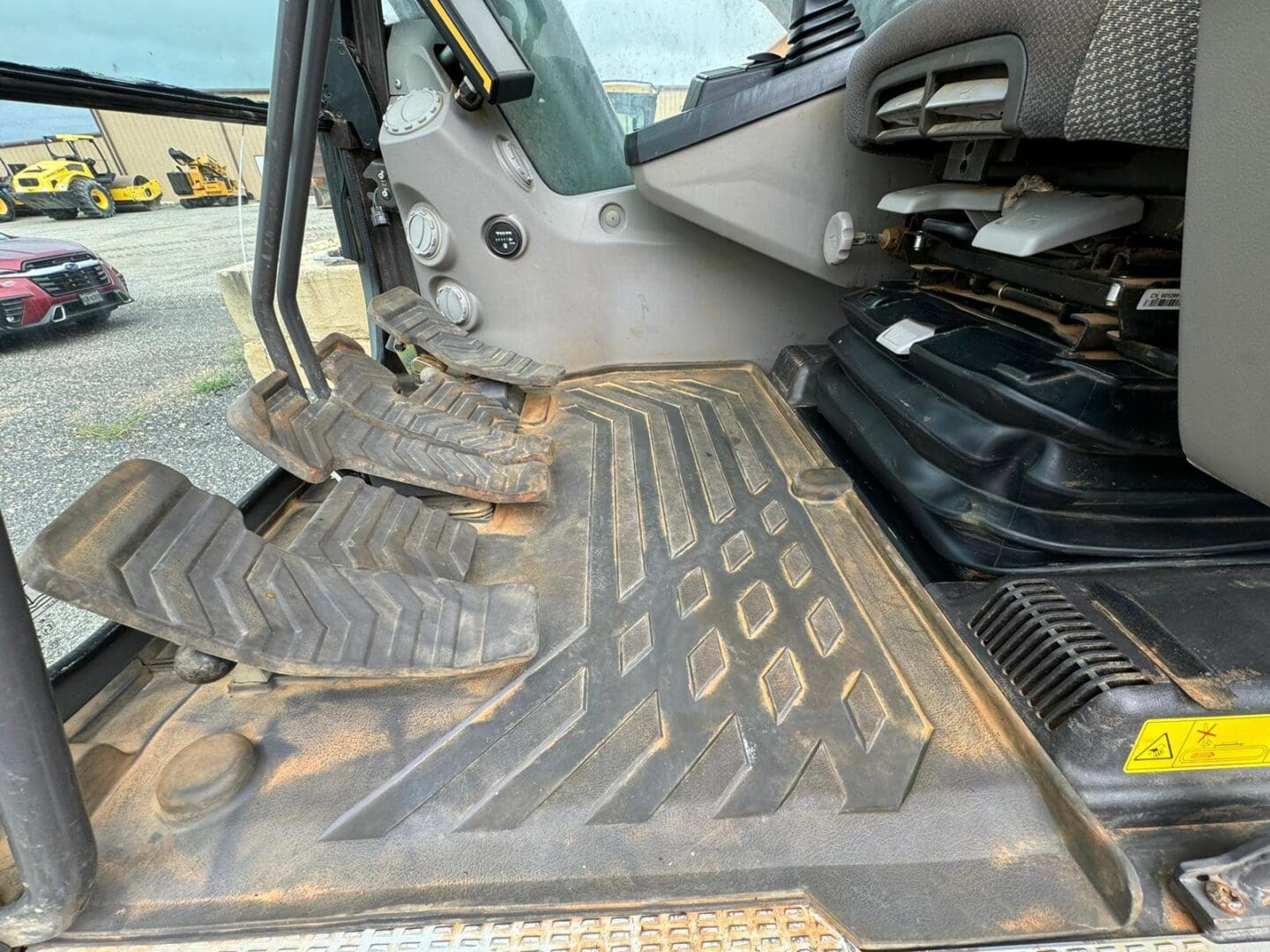 Dusty rubber floor mat and pedals in cab