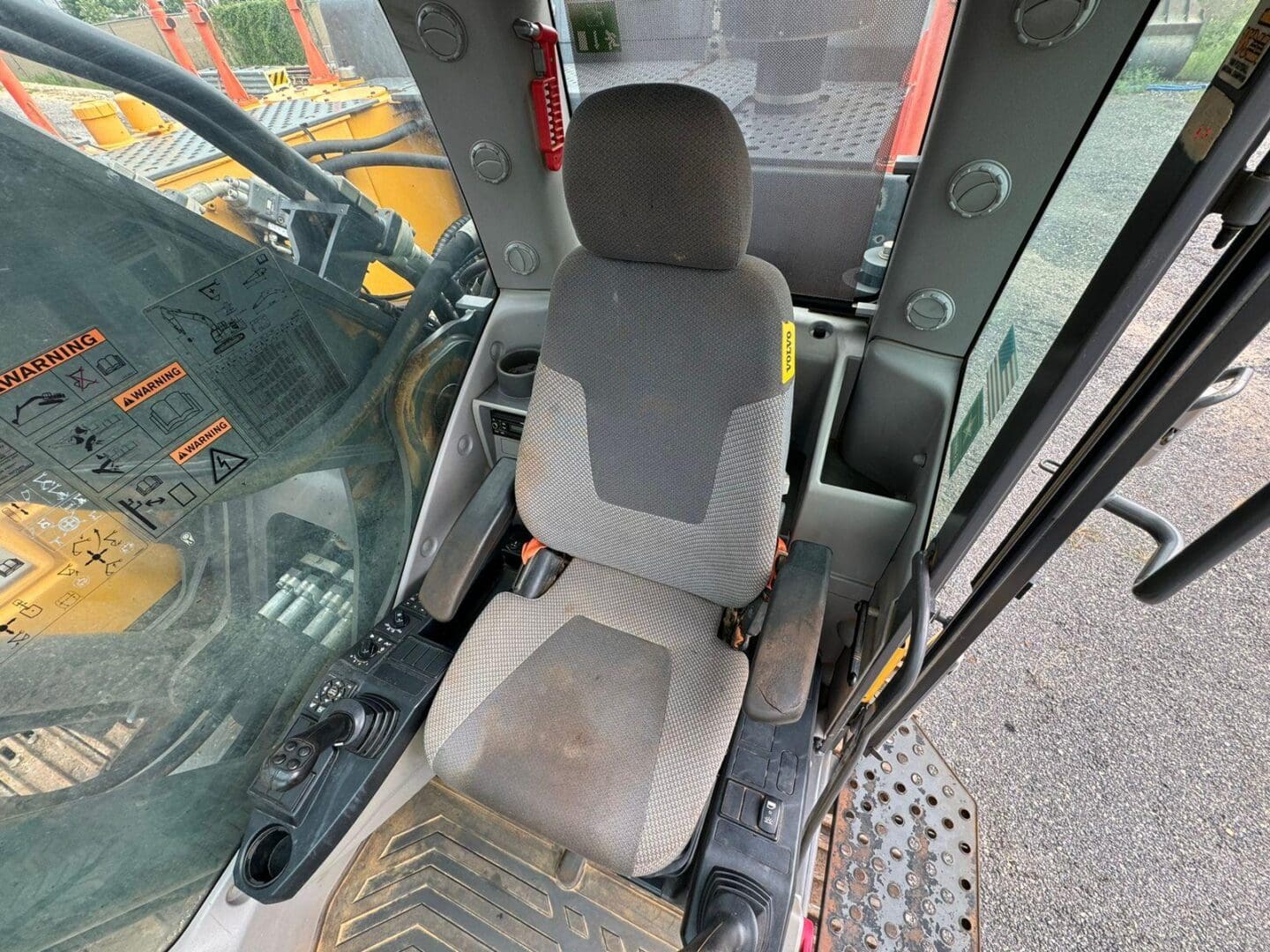 Excavator cab operator seat and controls