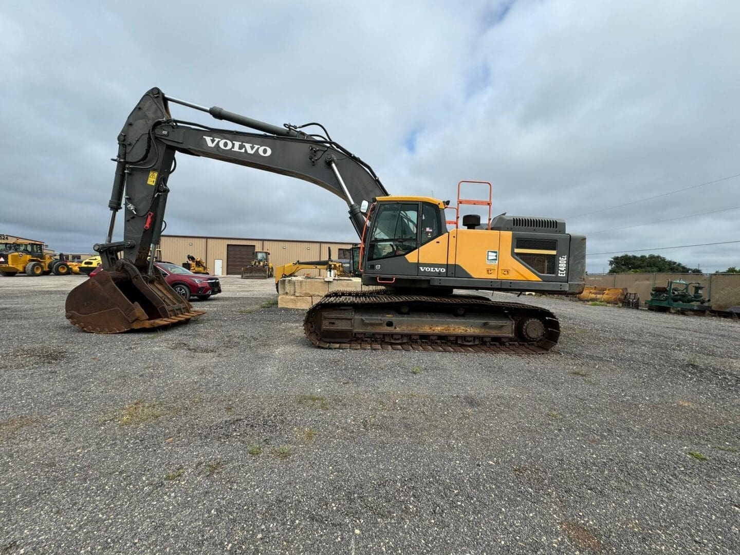 Yellow Volvo excavator parked on gravel lot