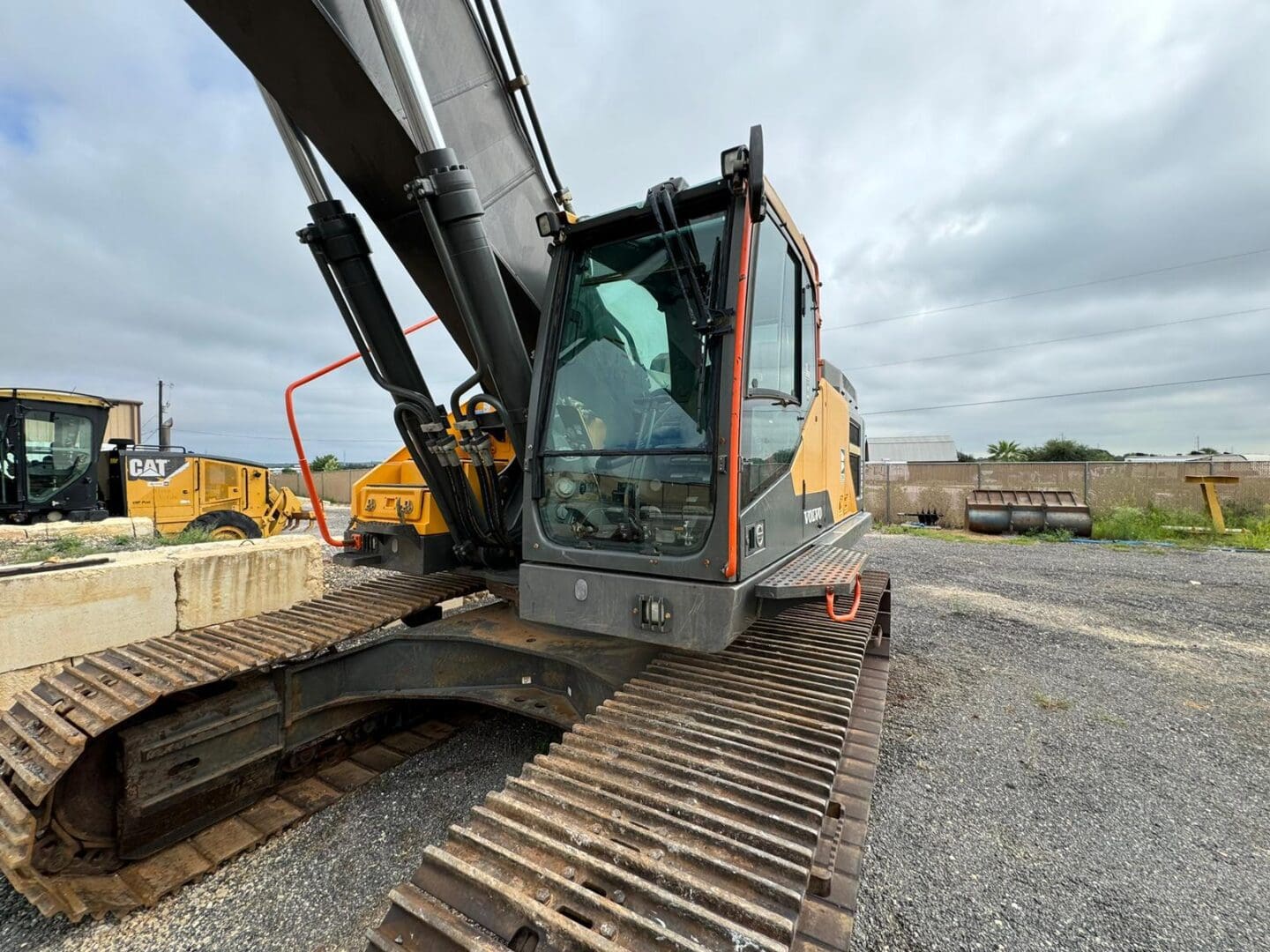 Large tracked excavator parked on gravel lot
