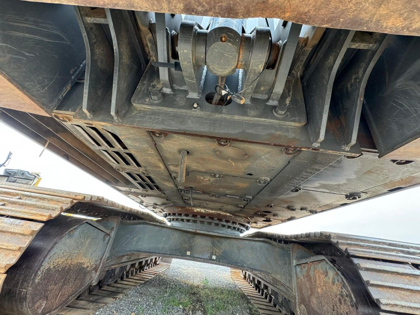 Underside of crawler excavator showing metal tracks