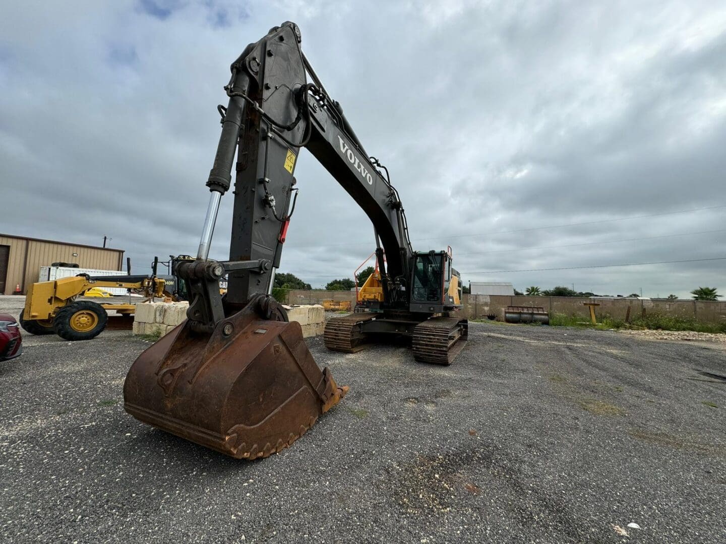 Volvo excavator with large bucket on lot