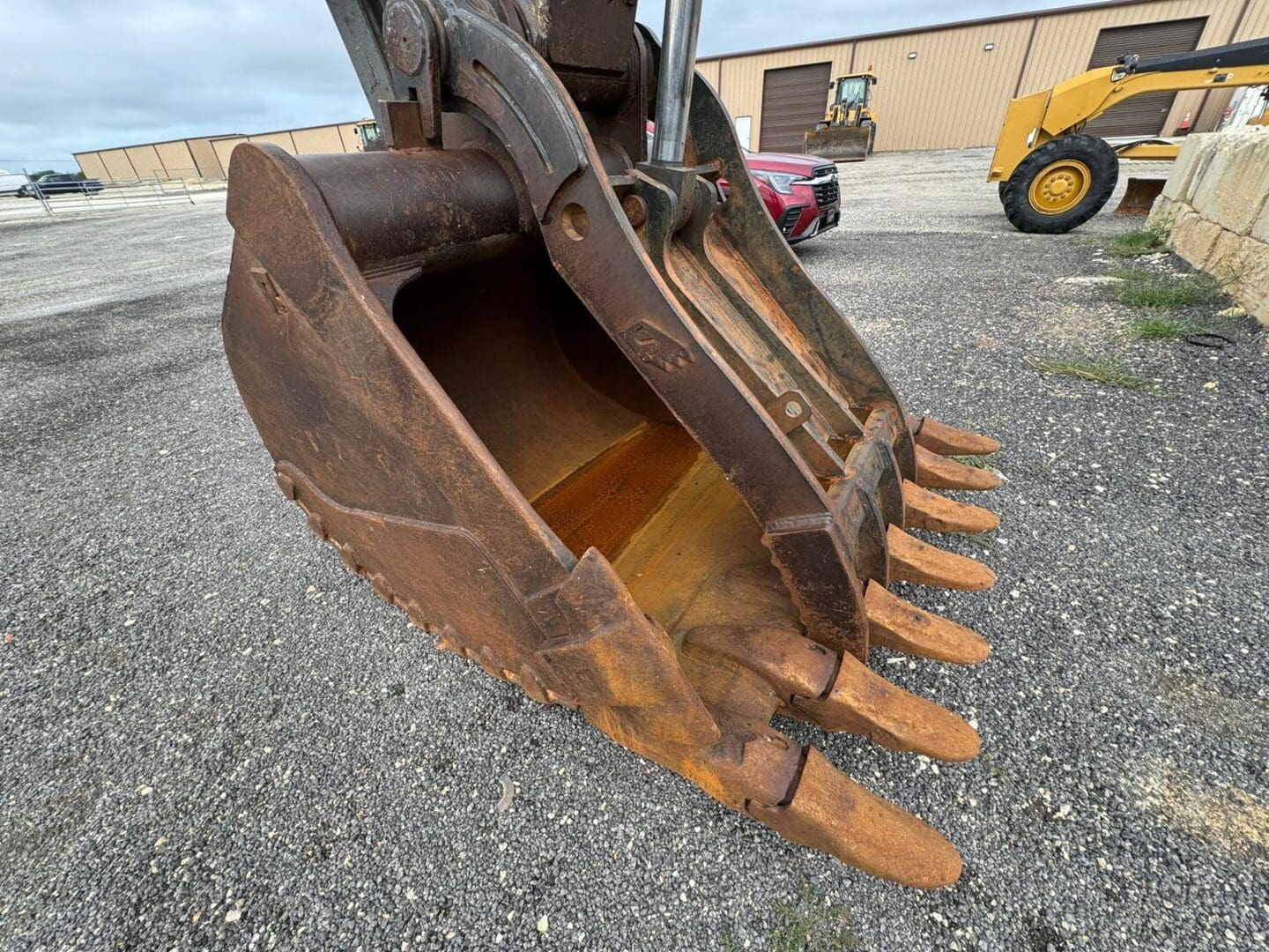 Rusty excavator bucket with teeth