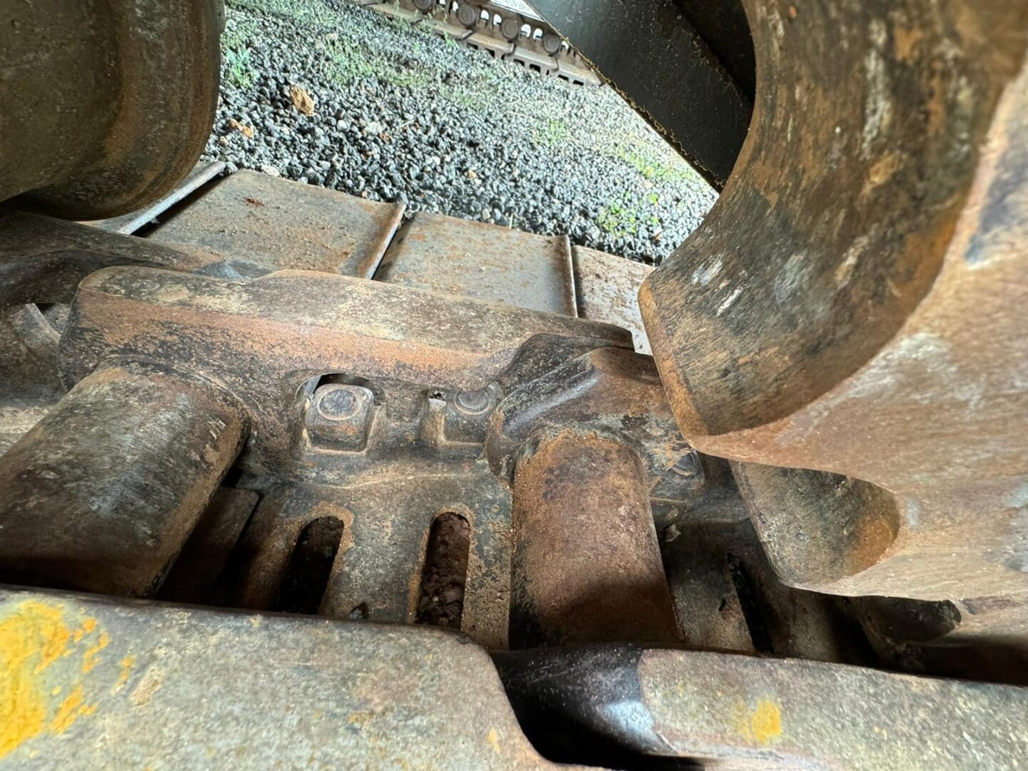 Rusted excavator track and roller close-up