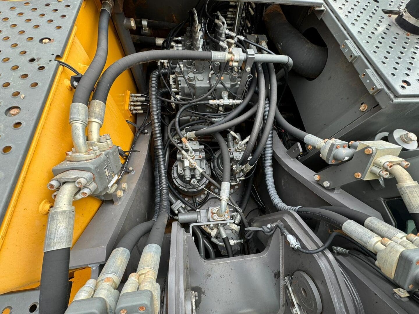 Hydraulic hoses and valves inside construction machinery