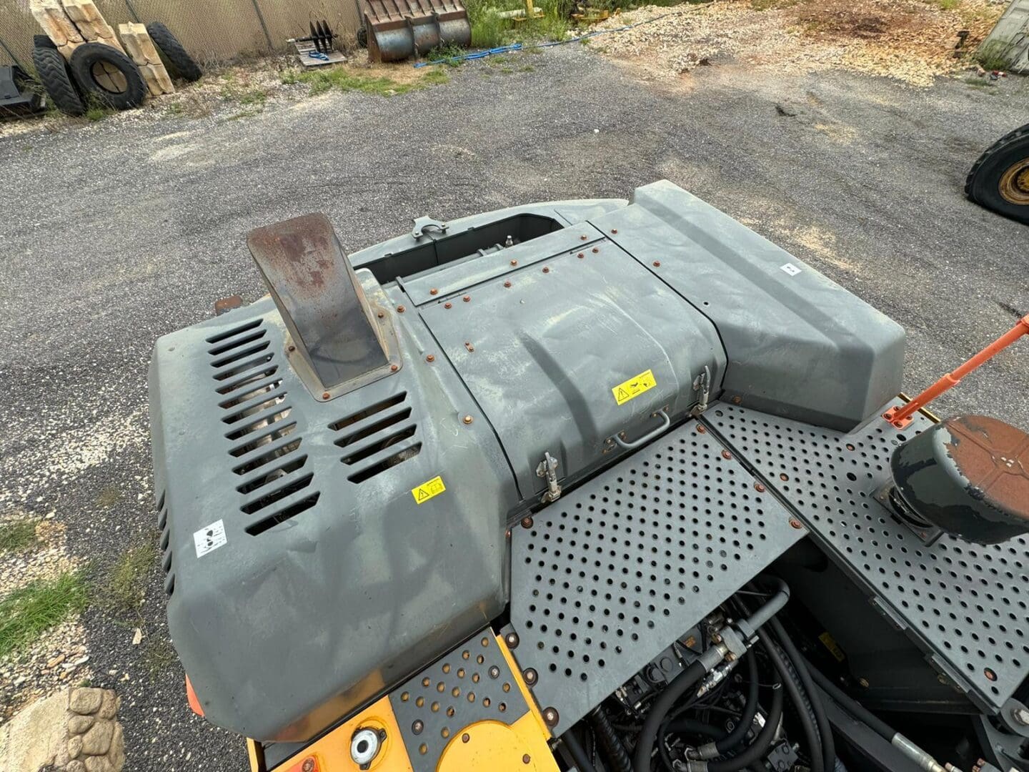 Construction equipment engine cover and perforated walkway