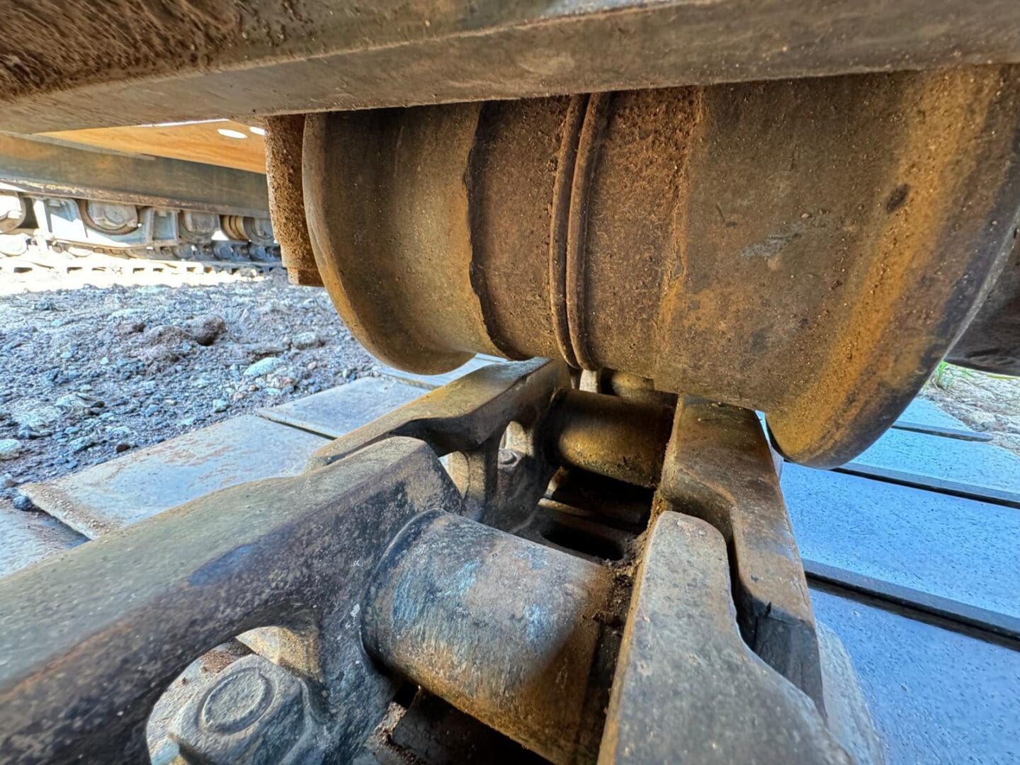 Rusty excavator track roller and link