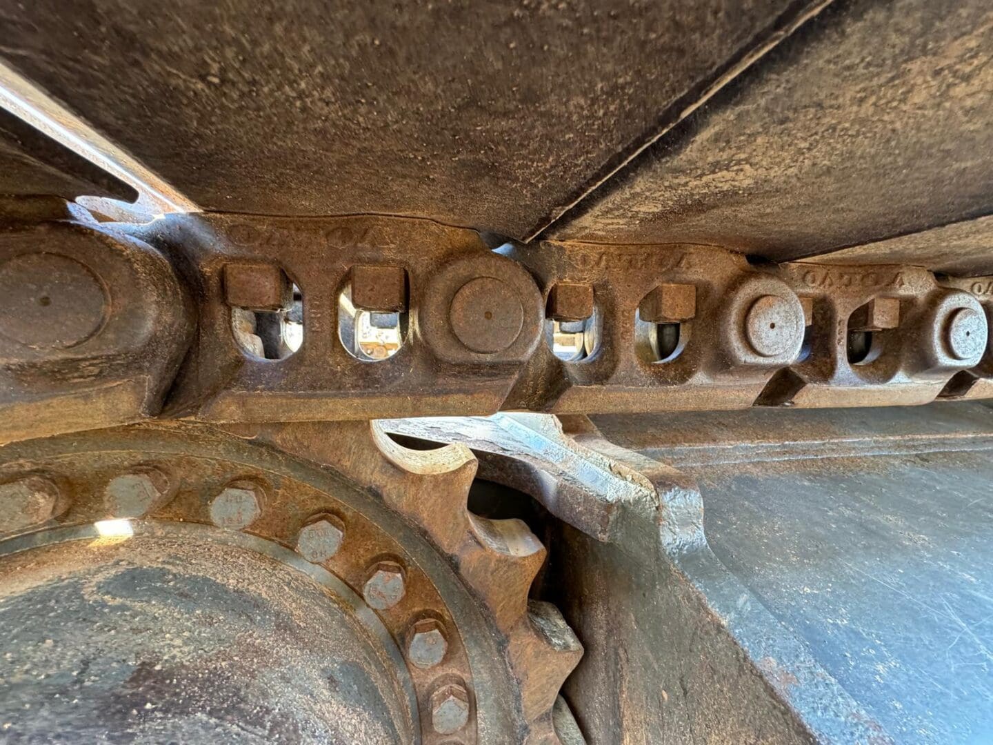 Rusty excavator track and sprocket closeup