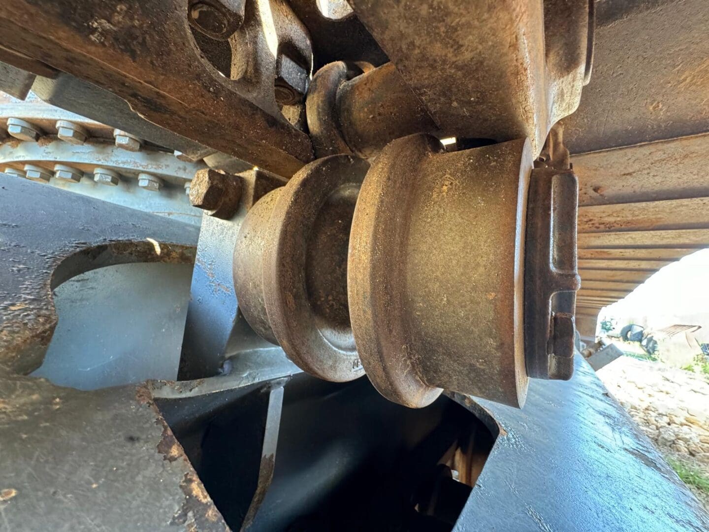 Rusty excavator track roller and sprocket