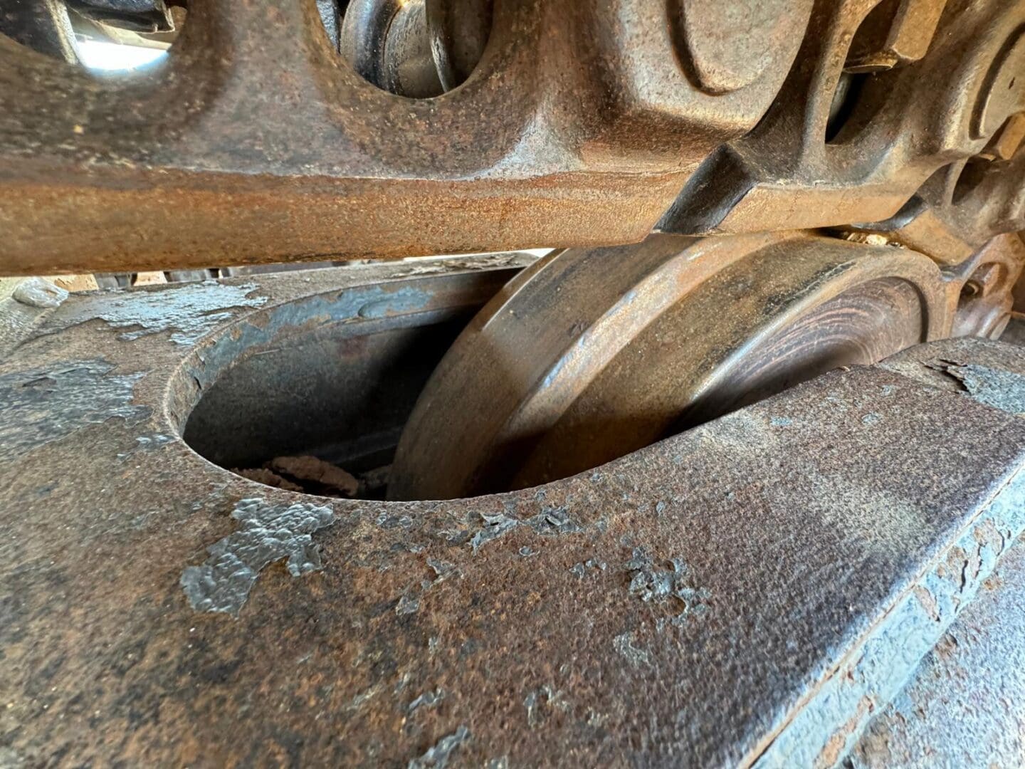 Rusty tracked vehicle undercarriage roller close-up