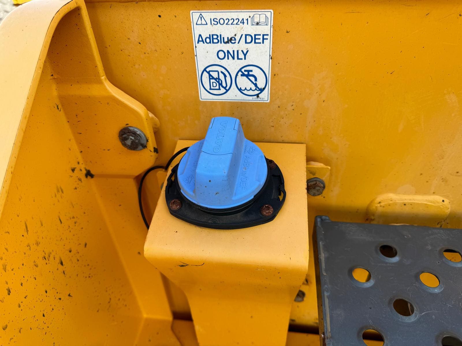 Blue AdBlue/DEF cap on yellow vehicle