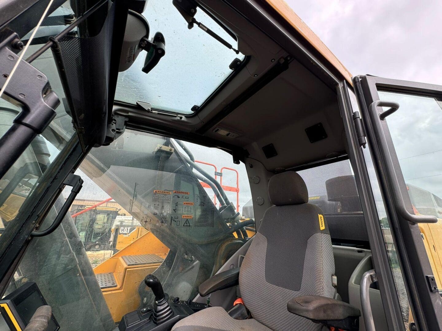 Construction equipment cab interior with joystick and seat