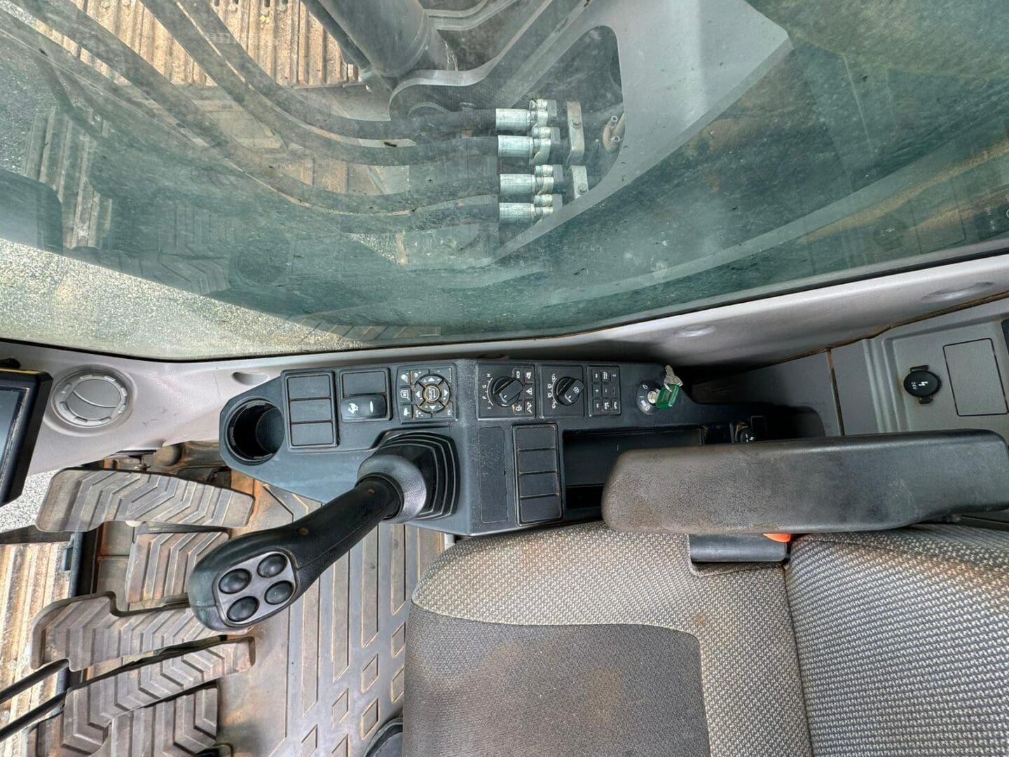 Excavator cab interior with joystick and controls