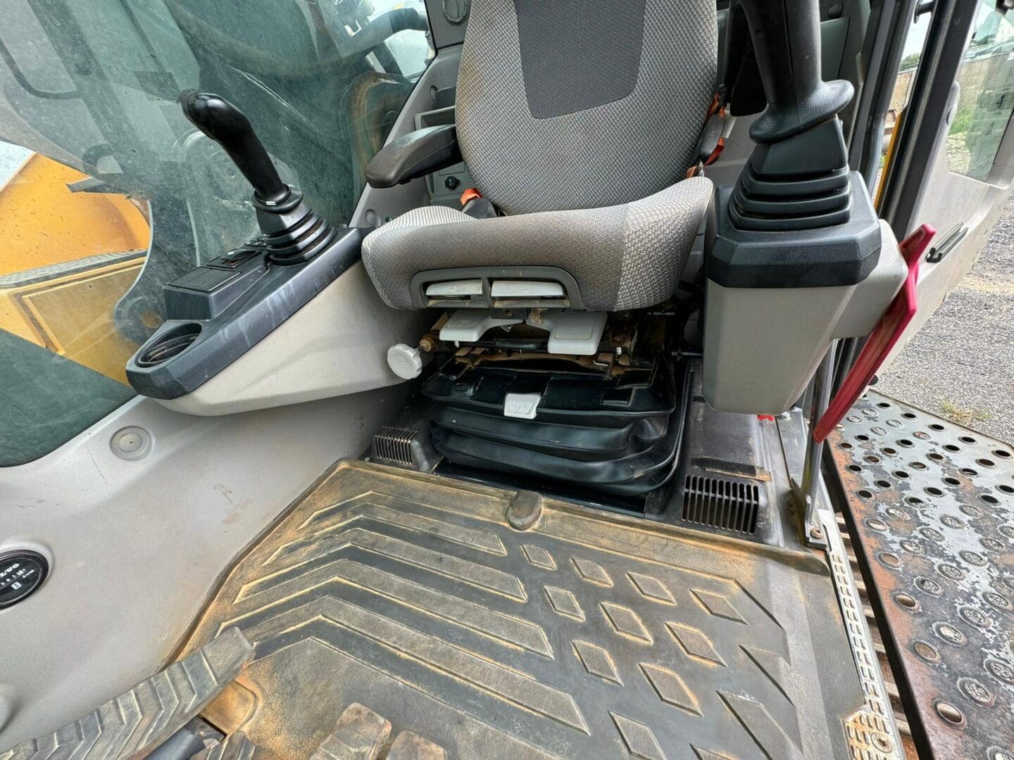 Excavator operator seat and control joysticks