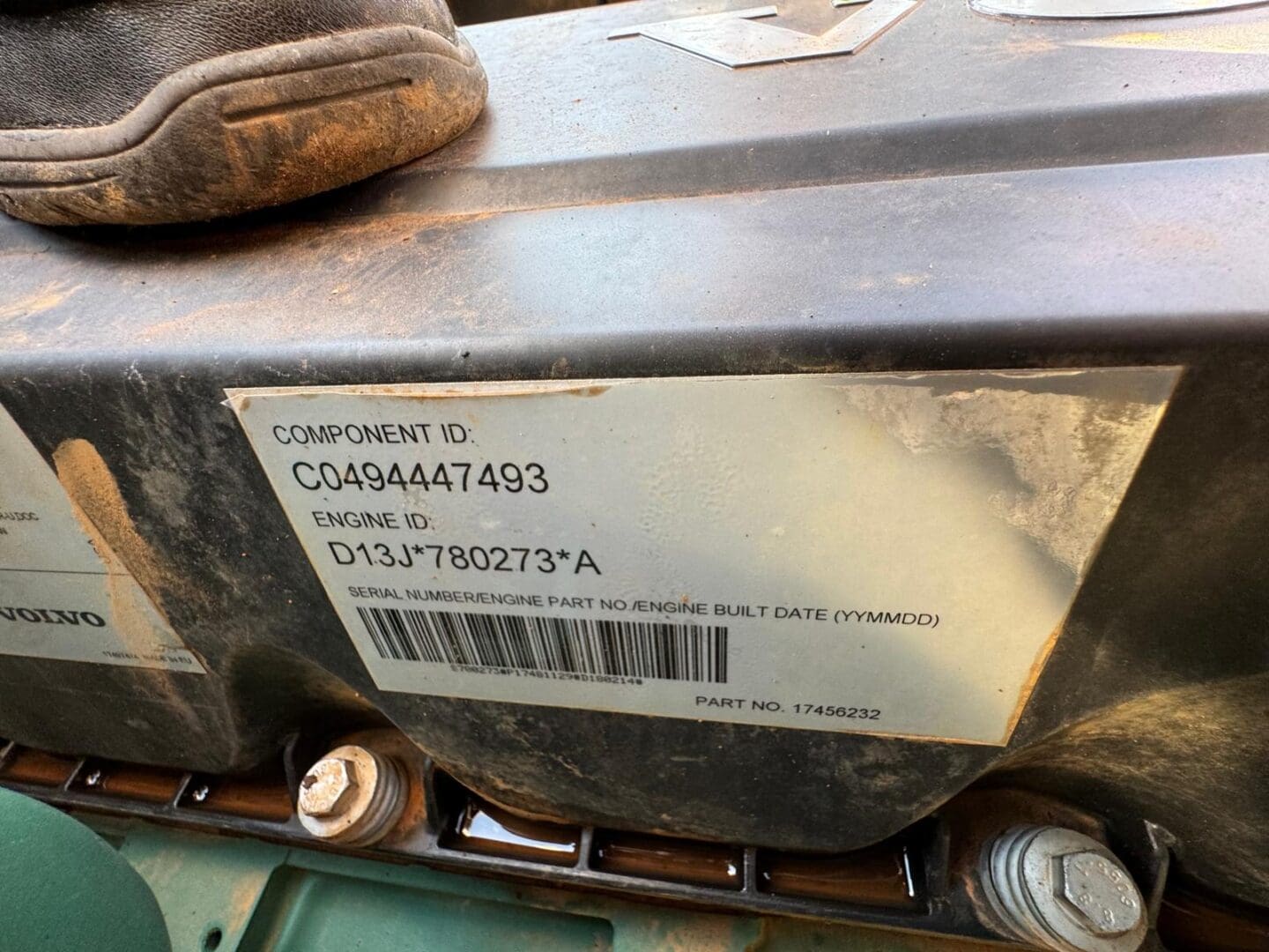 Dirty engine component label with barcode