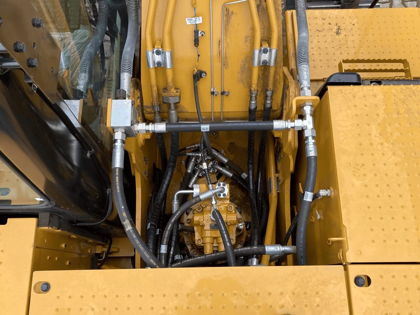 Close-up of excavator hydraulic hoses and fittings