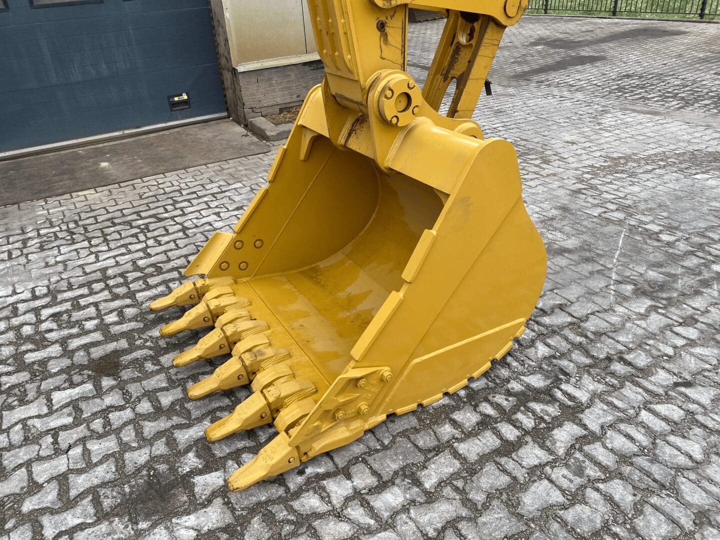 Yellow excavator bucket with digging teeth