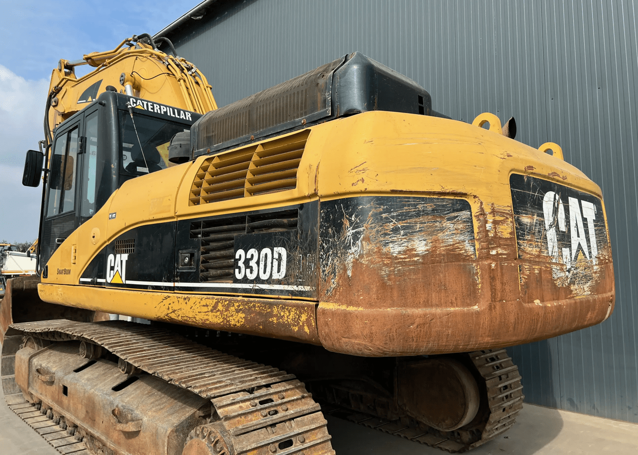Yellow Caterpillar 330D excavator with tracked treads