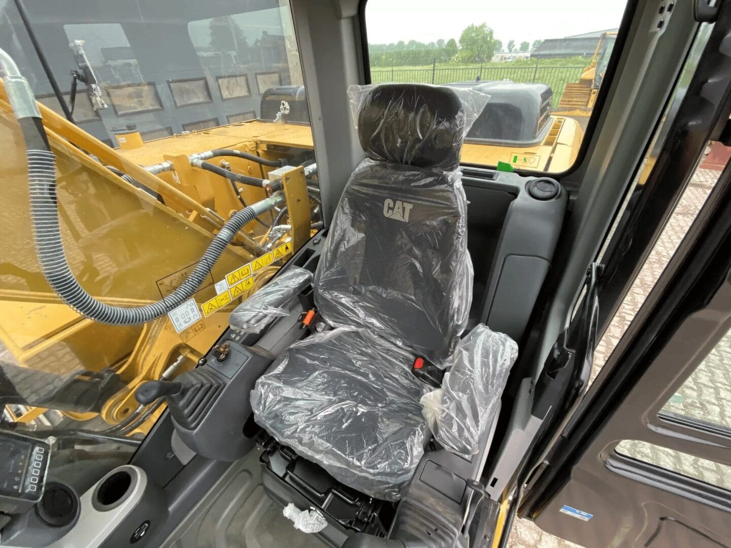 CAT excavator seat wrapped in plastic