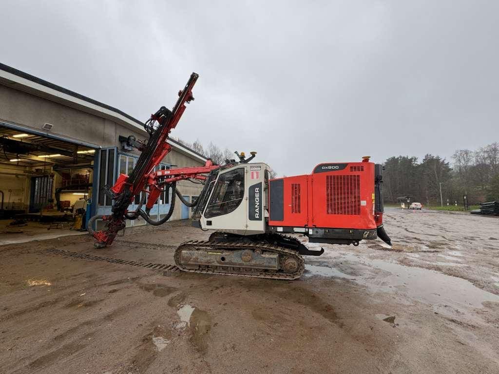 Red and white crawler drilling rig
