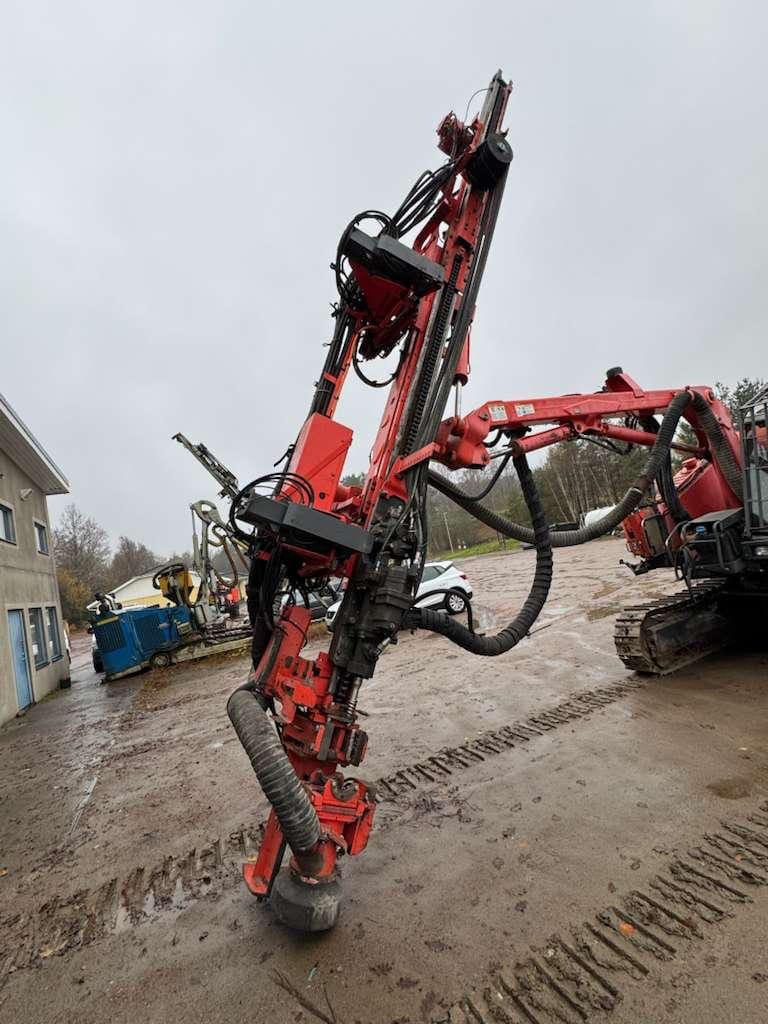 Red crawler-mounted rock drill rig