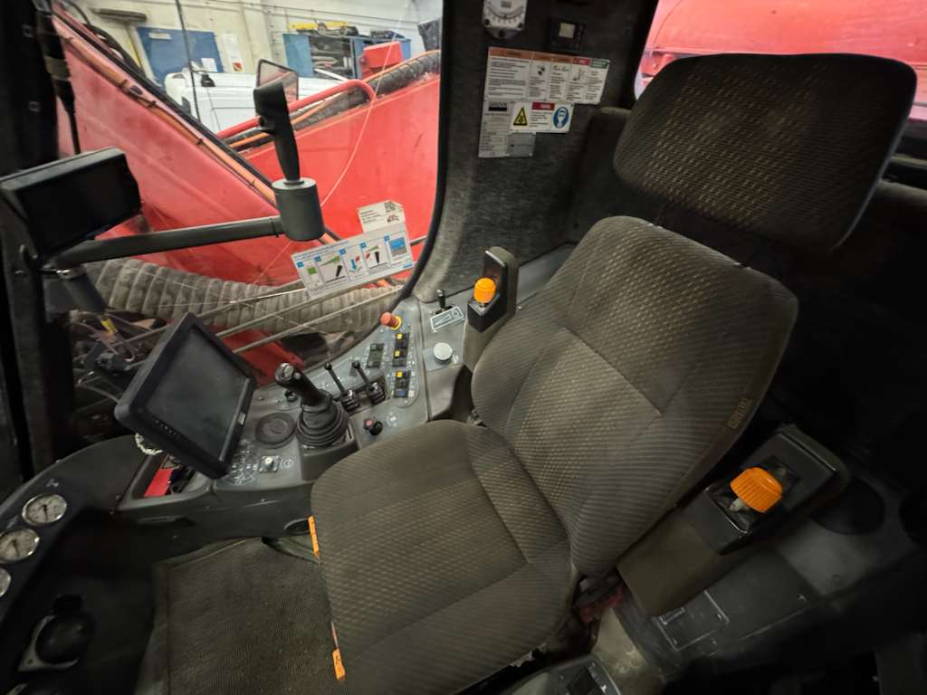 Heavy equipment cab with seat and controls
