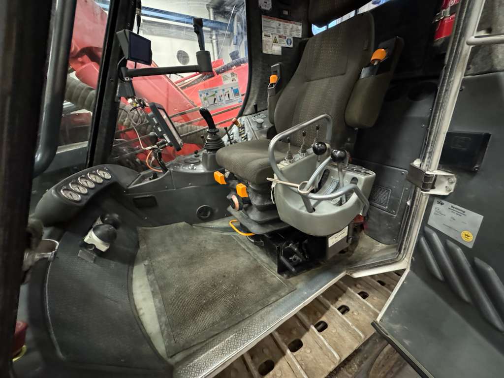 Tractor cab interior with operator seat and controls