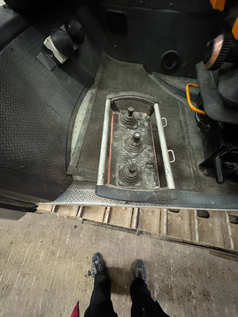 Construction vehicle footwell with three joystick controls