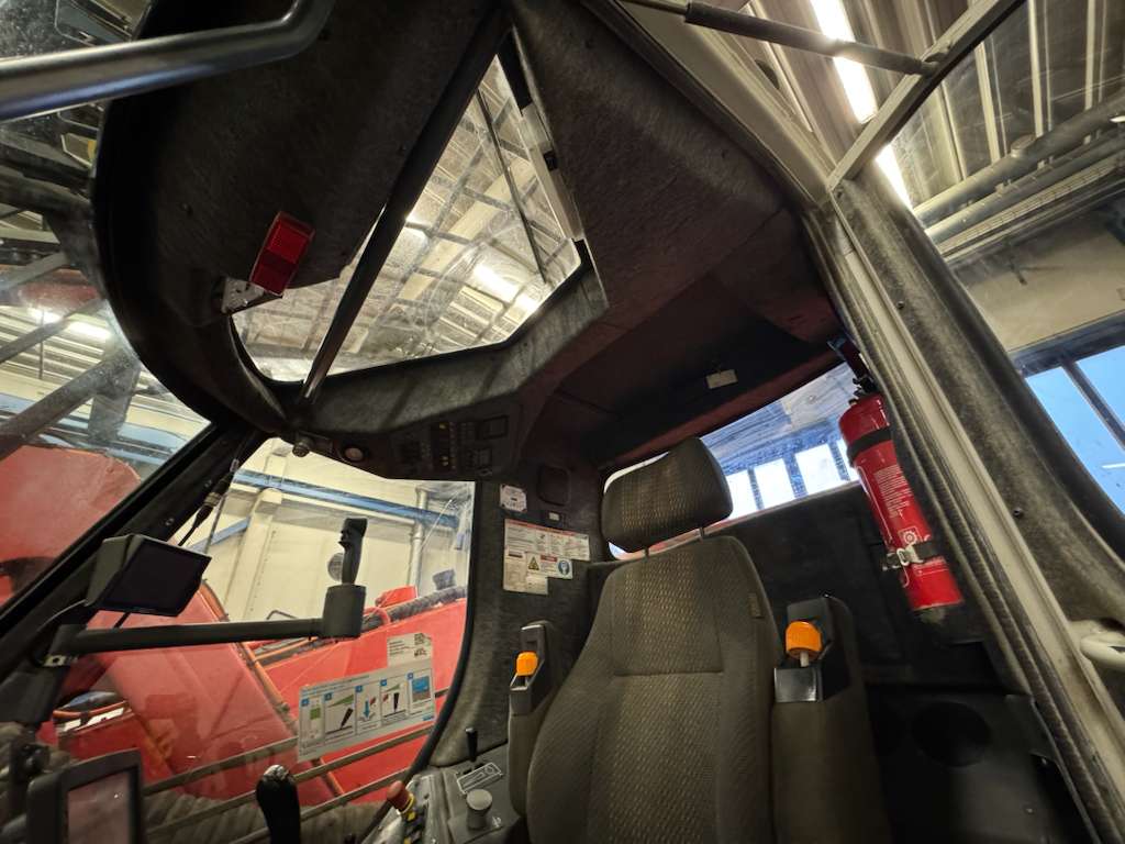 Heavy equipment cab interior with seat and controls