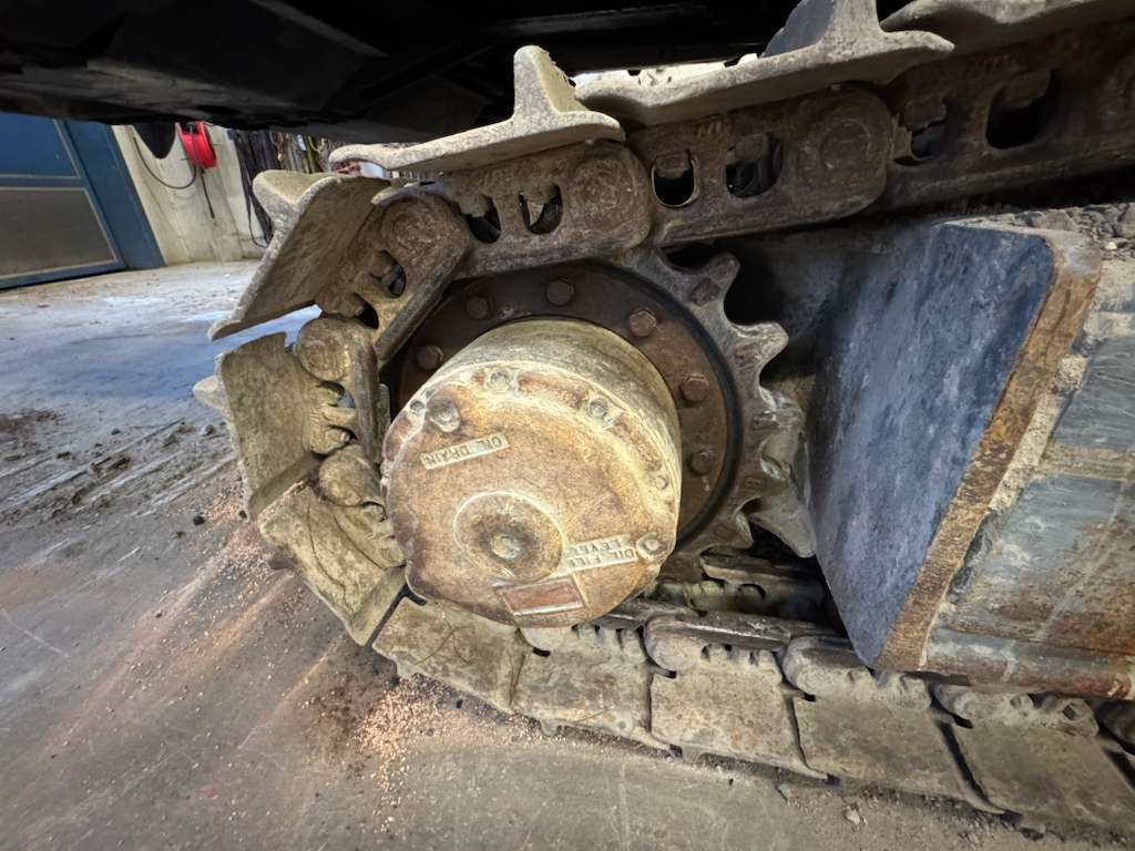 Close-up of excavator sprocket and track