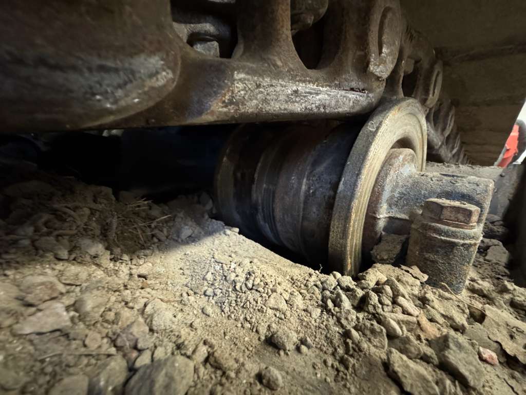 Excavator track roller and muddy ground