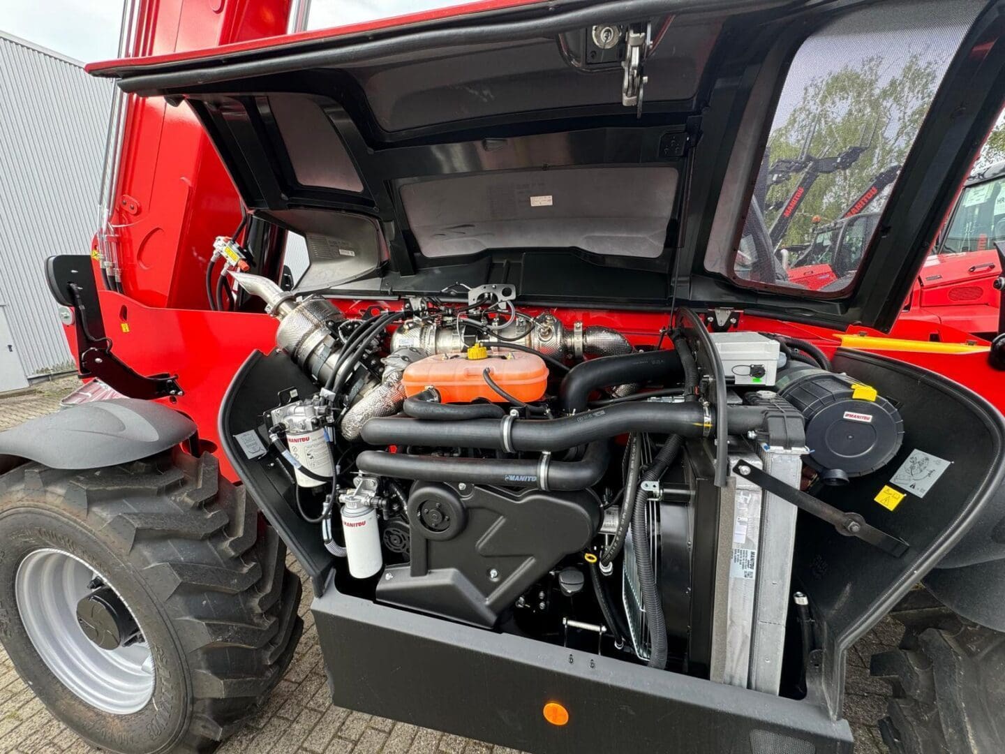 Red tractor with open engine compartment