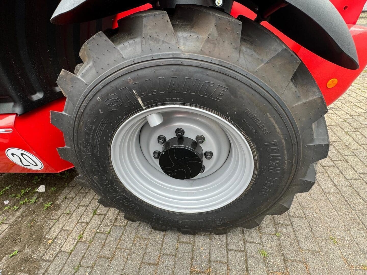 Large tractor tire on red machinery