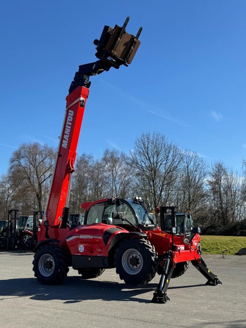 Red Manitou telehandler with extended pallet fork