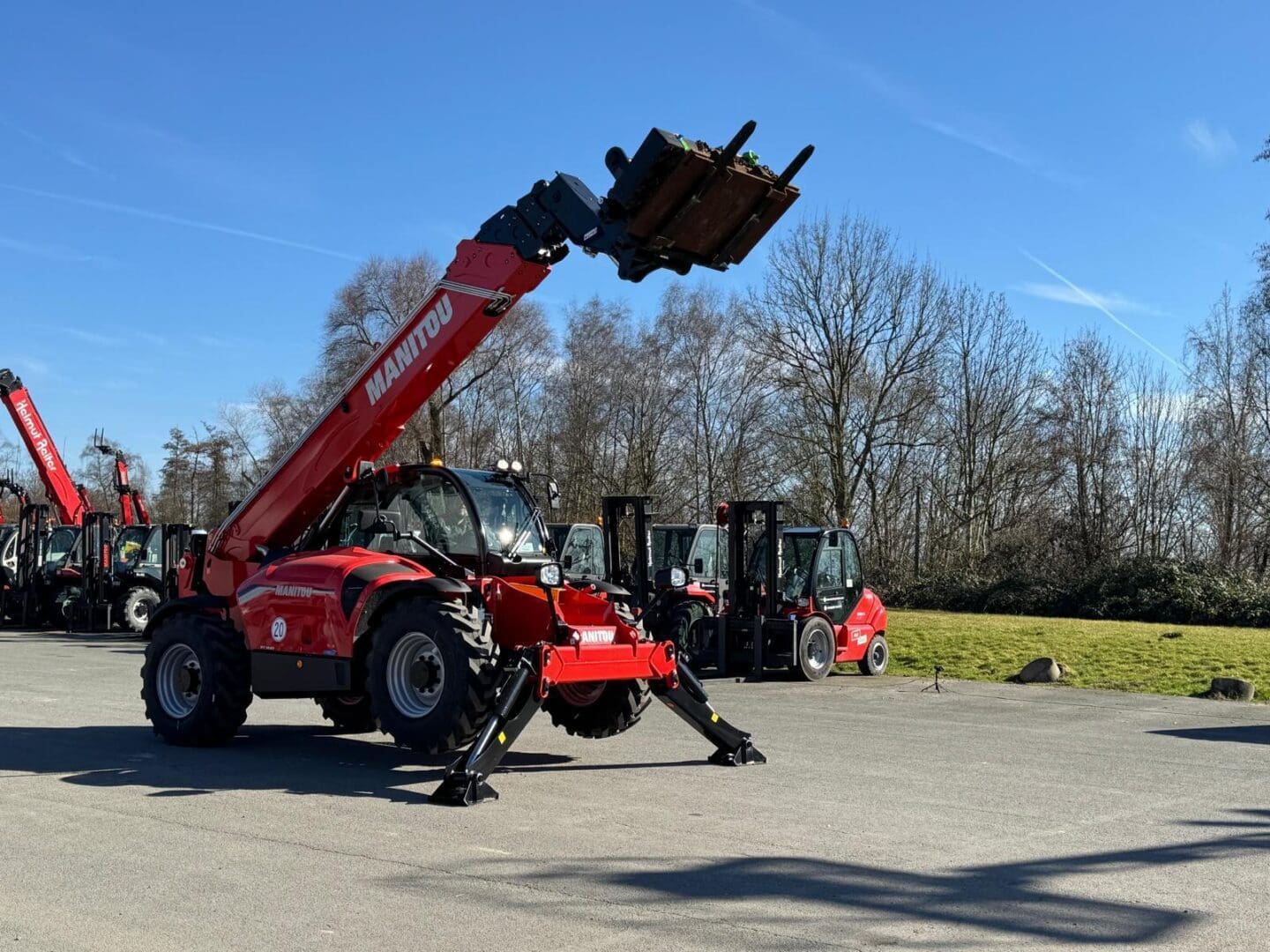 Red Manitou telehandler with raised forks