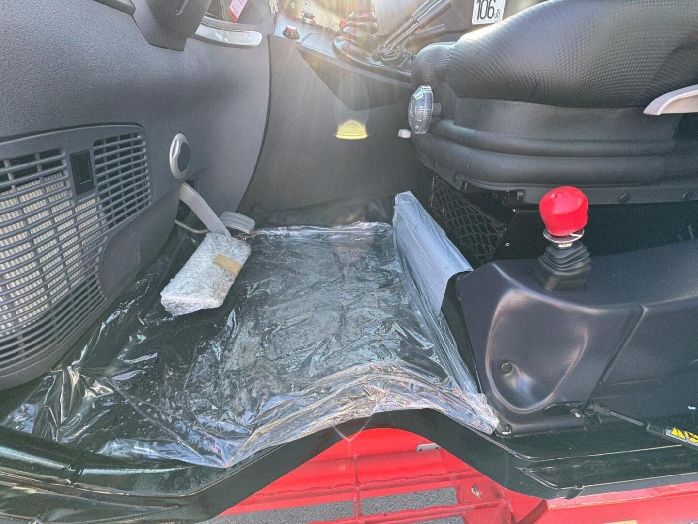Cabin floor with plastic cover and red knob