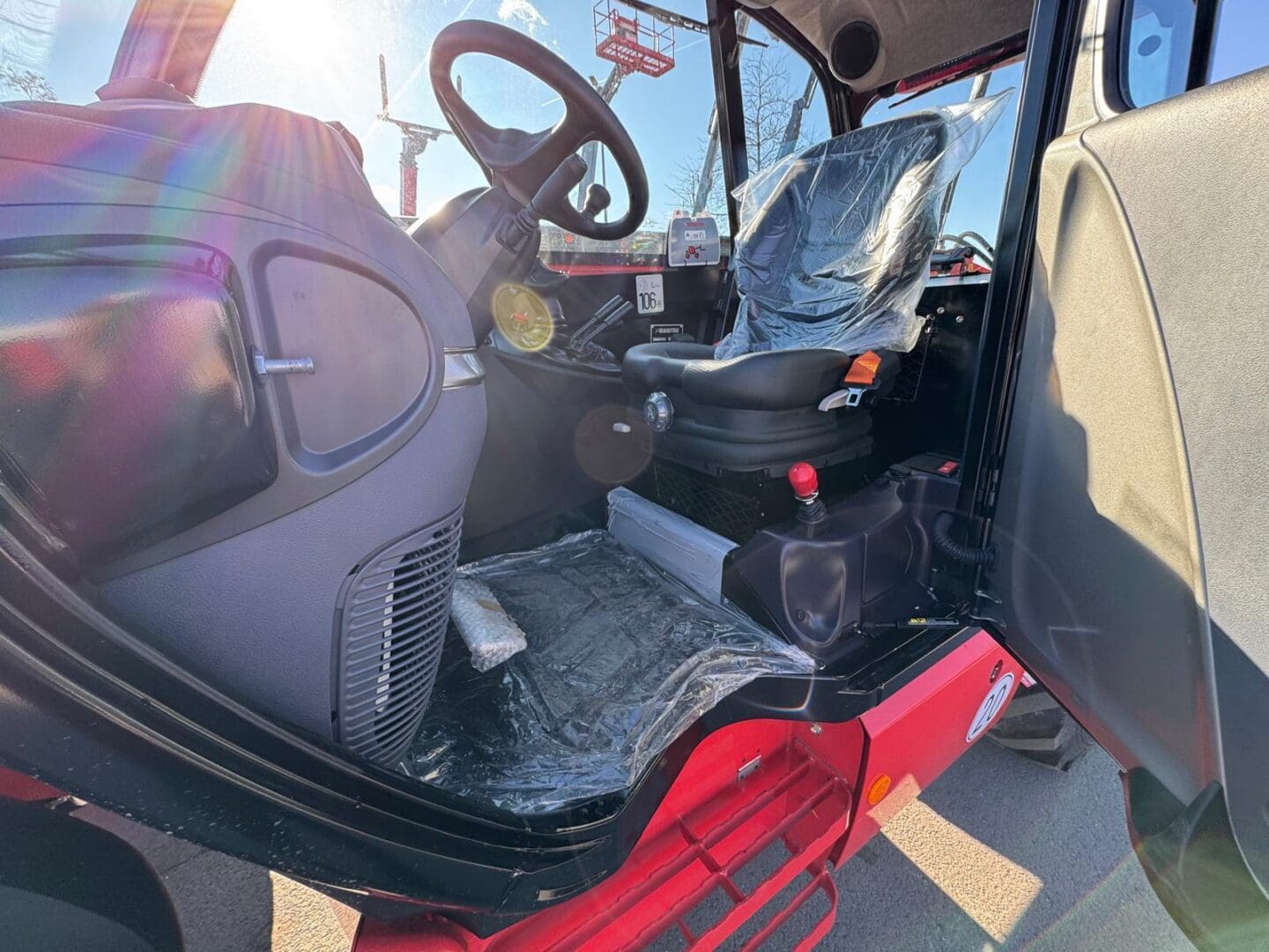 Tractor cabin interior with plastic covered seat