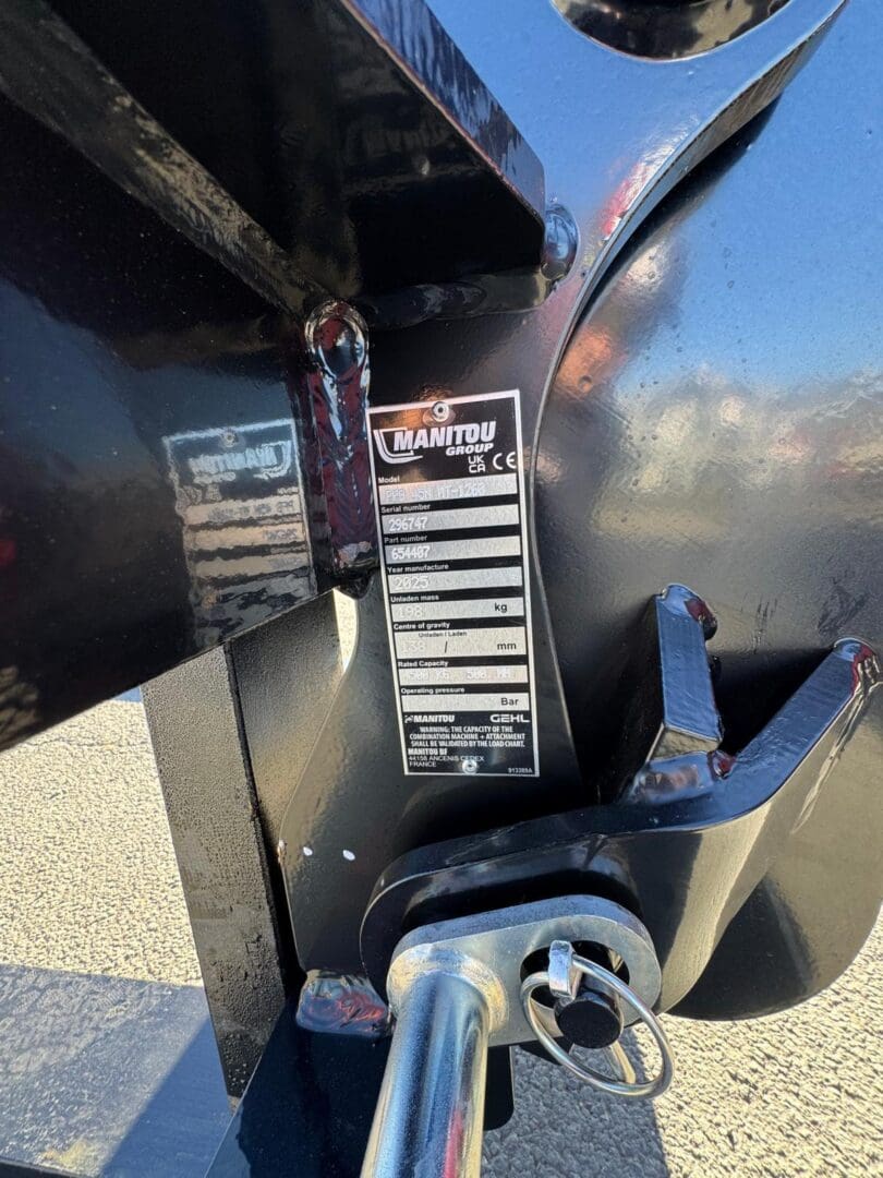 Close-up Manitou equipment label and locking pin