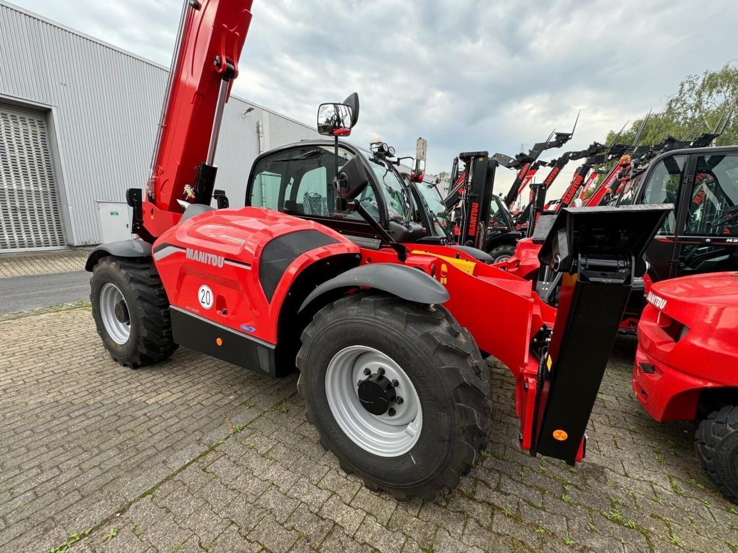 Red Manitou telescopic handler in equipment yard
