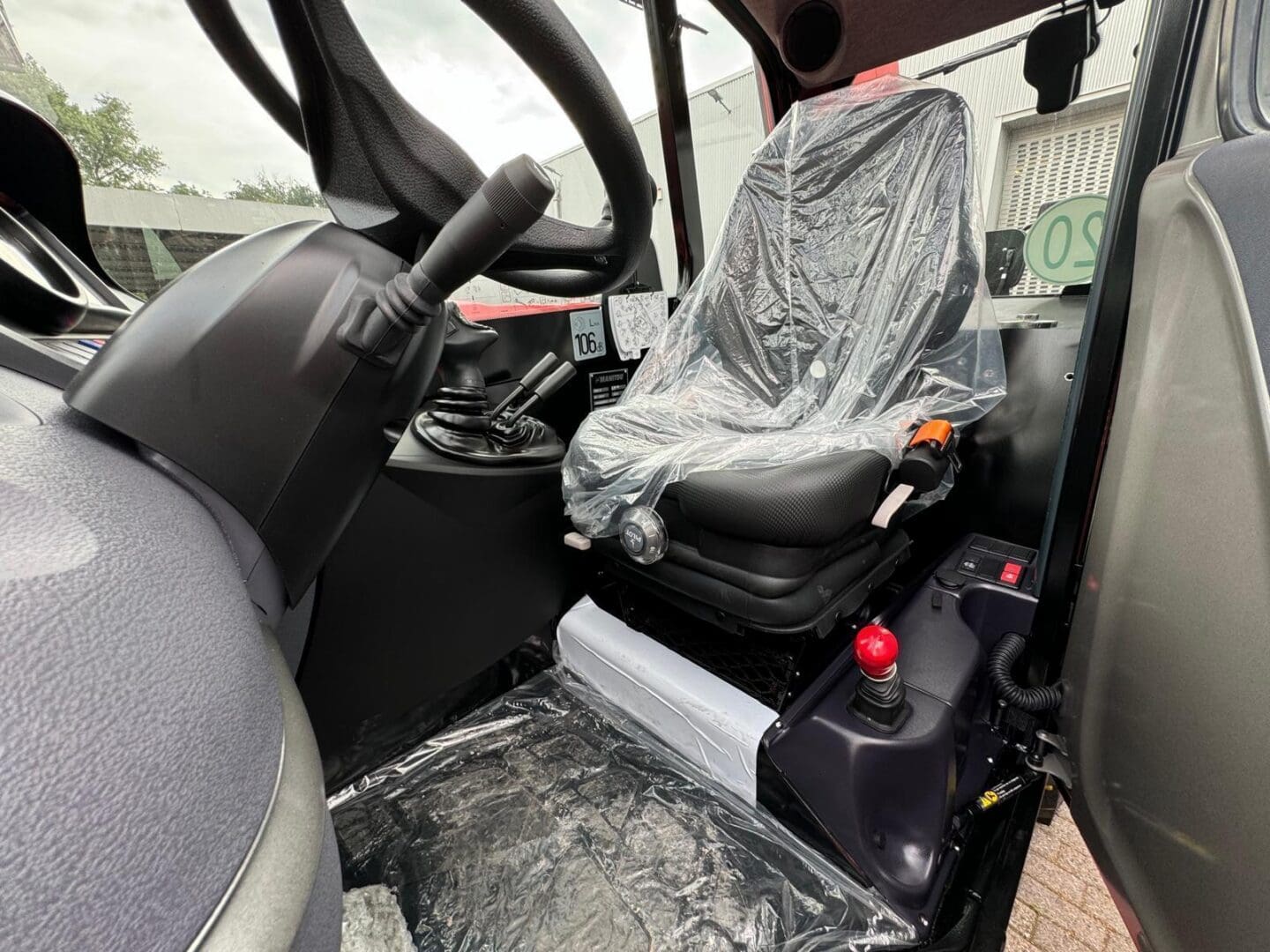 Cab interior with plastic-covered driver seat