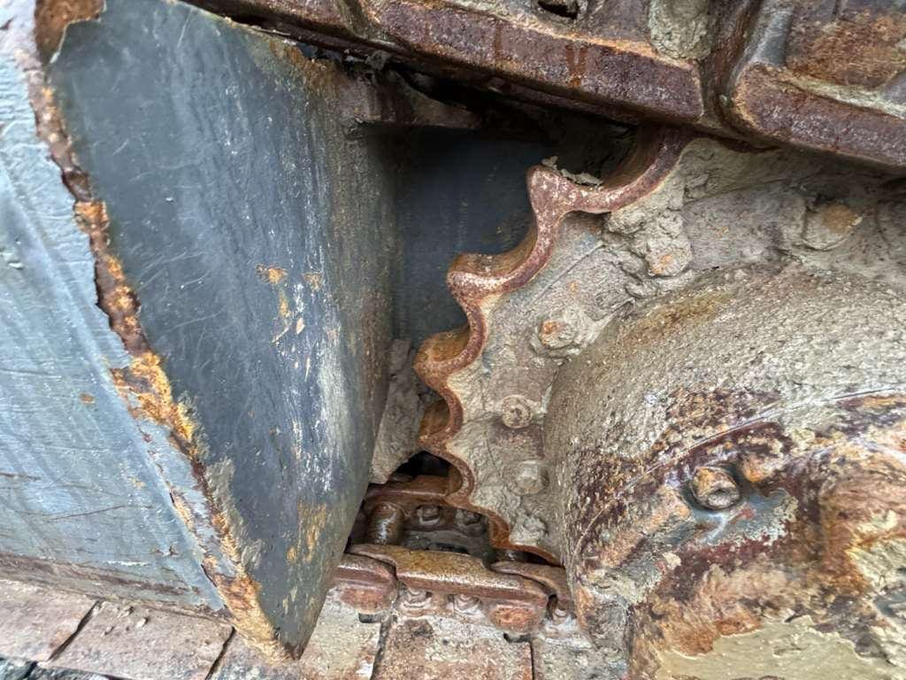 Rusty industrial sprocket and chain close-up
