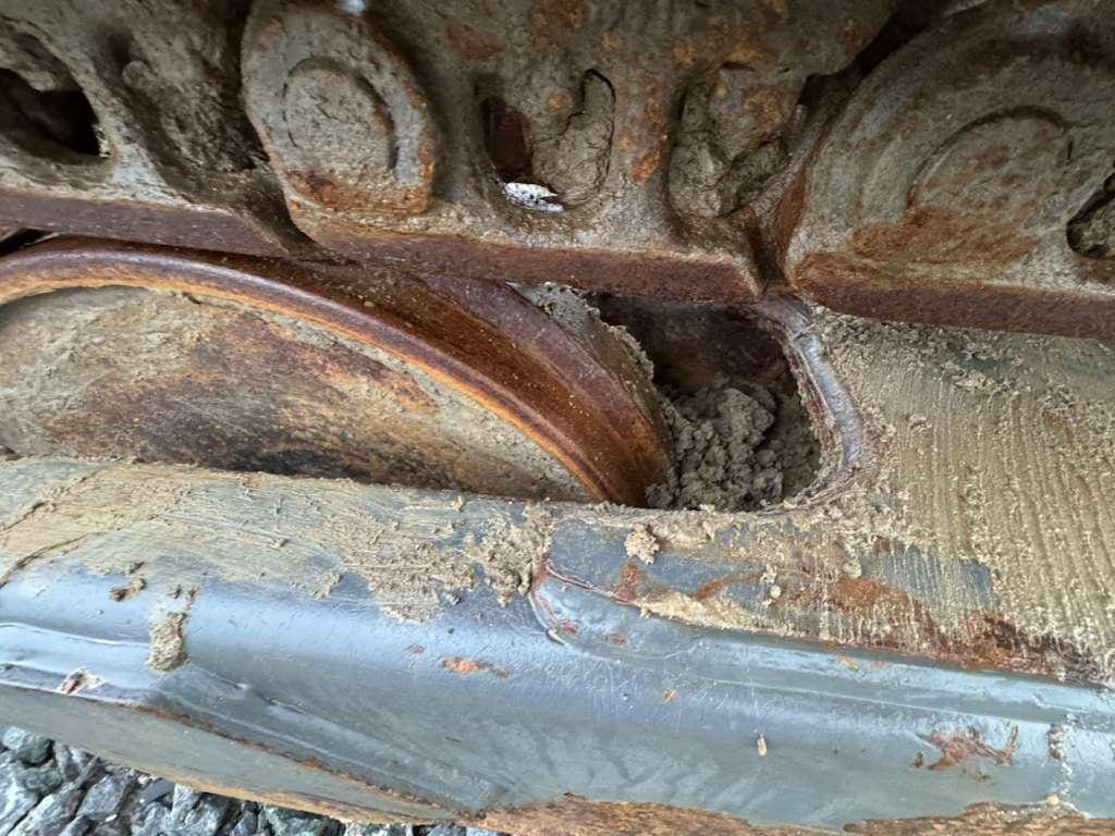 Rusted metal track wheel on heavy machinery