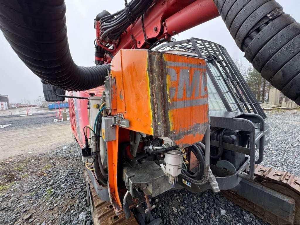 Orange drilling rig attachment on construction site