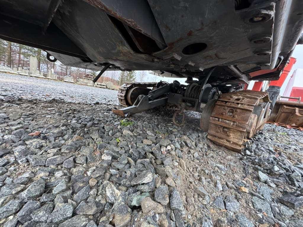 Mini excavator tracks and undercarriage on gravel
