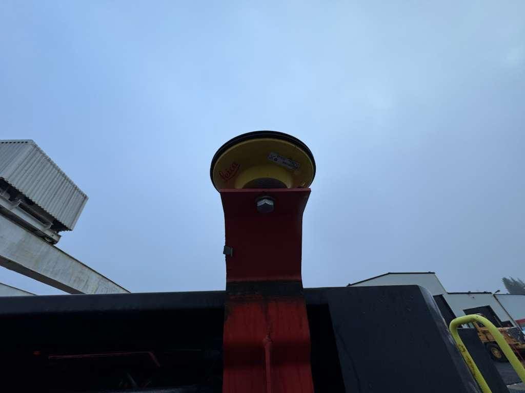 Yellow warning siren mounted on red bracket