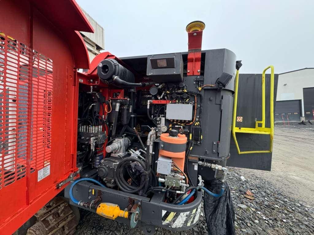 Open engine compartment of red industrial machine